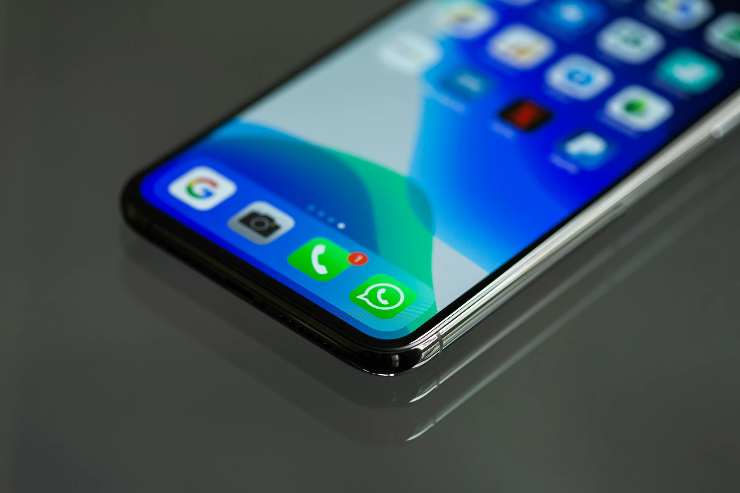 a close up of a cell phone on a table, a digital rendering, pexels, blue and green, whatsapp, 2 5 6 x 2 5 6, oled