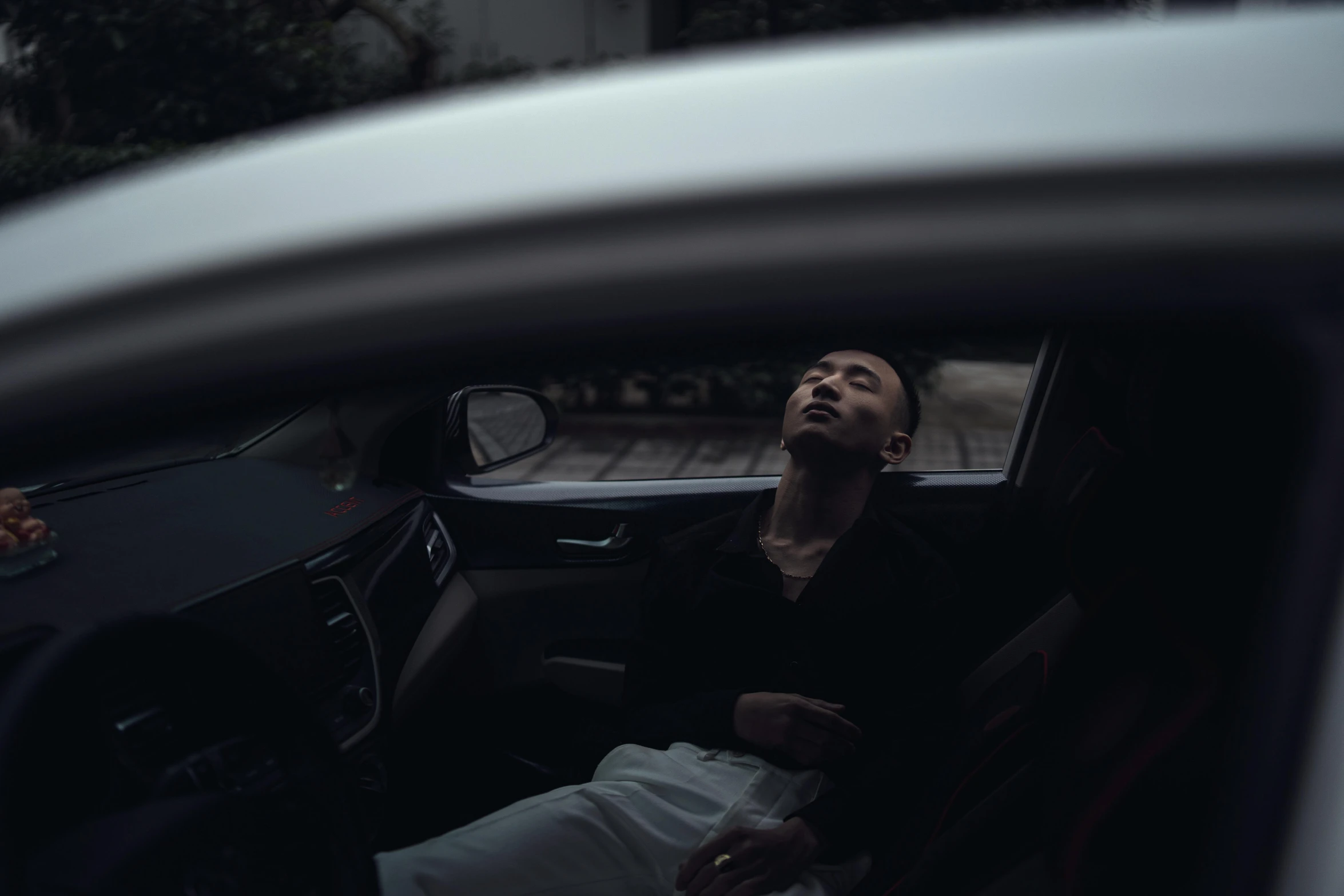 a man sitting in a car talking on a cell phone, an album cover, by Elsa Bleda, pexels contest winner, snoring, asian man, unconscious, ' lost in a lucid dream