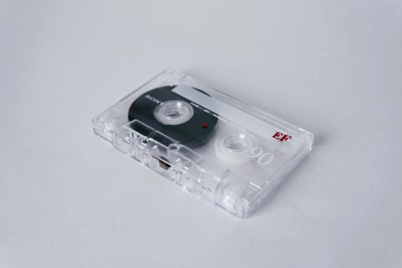 a cassette player sitting on top of a white surface, an album cover, inspired by Elsa Bleda, unsplash, computer art, made out of clear plastic, ignant, close up shot from the side, eight eight eight