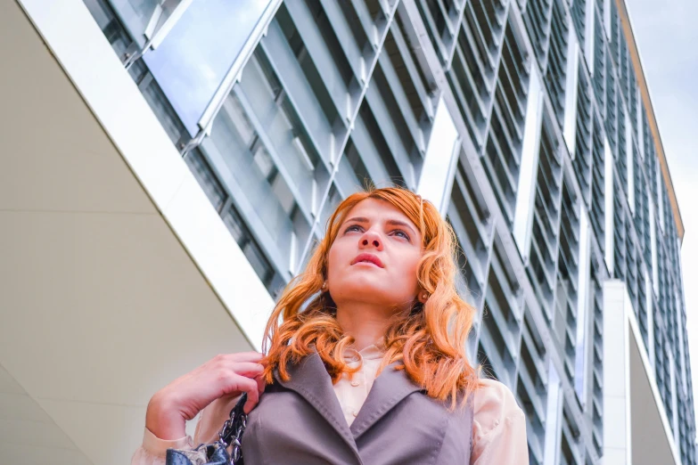 a woman standing in front of a tall building, pexels contest winner, renaissance, a redheaded young woman, serious business, female marty mcfly, people at work