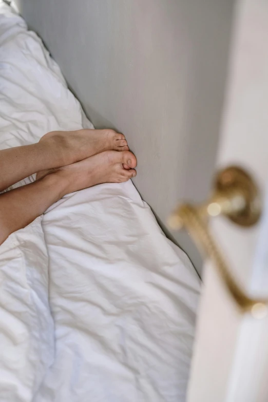 a close up of a person laying in a bed, exposed toes, profile image, contented, the best