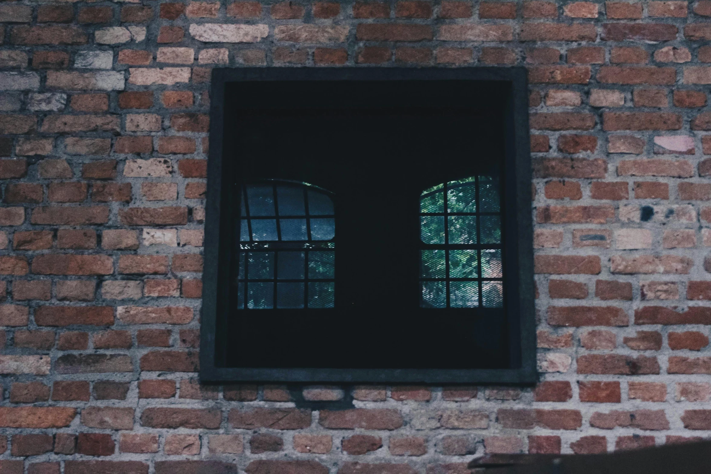 a close up of a window on a brick wall, inspired by Elsa Bleda, pexels contest winner, with a square, haunted house interior, black windows, background image