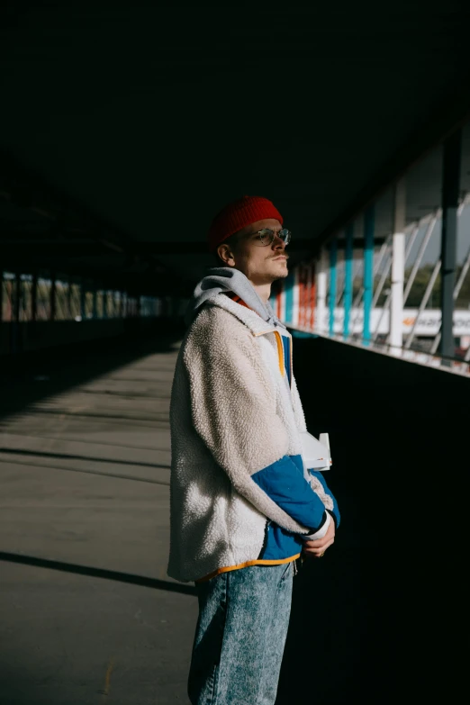 a man in a white jacket and a red hat, unsplash, mr beast, high quality photo, multiple stories, with backlight