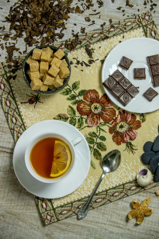 a table topped with plates of food and a cup of tea, inspired by Eugène Isabey, qajar art, fully chocolate, thumbnail, square, high angle close up shot