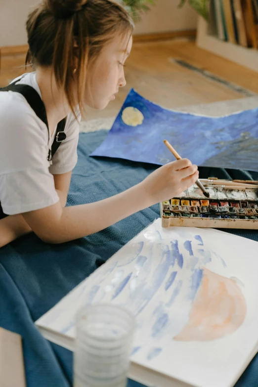 a young girl sitting on a bed painting, a watercolor painting, inspired by Arthur Streeton, pexels contest winner, painting a canvas, a high angle shot, on a canva, watercolor painting underwater