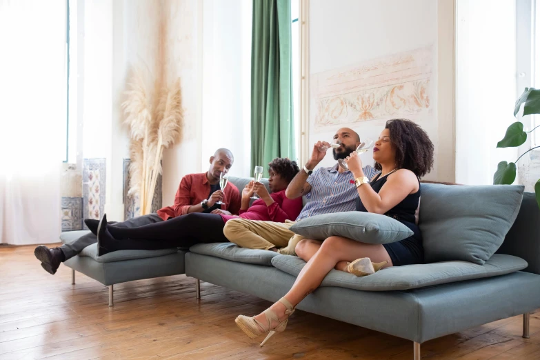 a group of people sitting on a couch in a living room, pexels contest winner, figuration libre, wine, profile image, airbnb, diverse