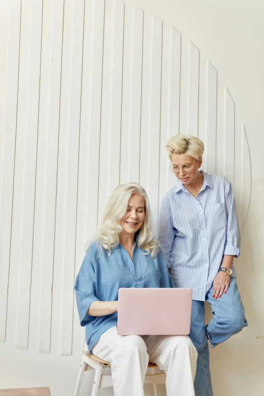 a couple of women sitting next to each other on a chair, a photo, pexels, computer art, wearing a light blue shirt, silver haired, flatlay, nordic pastel colors