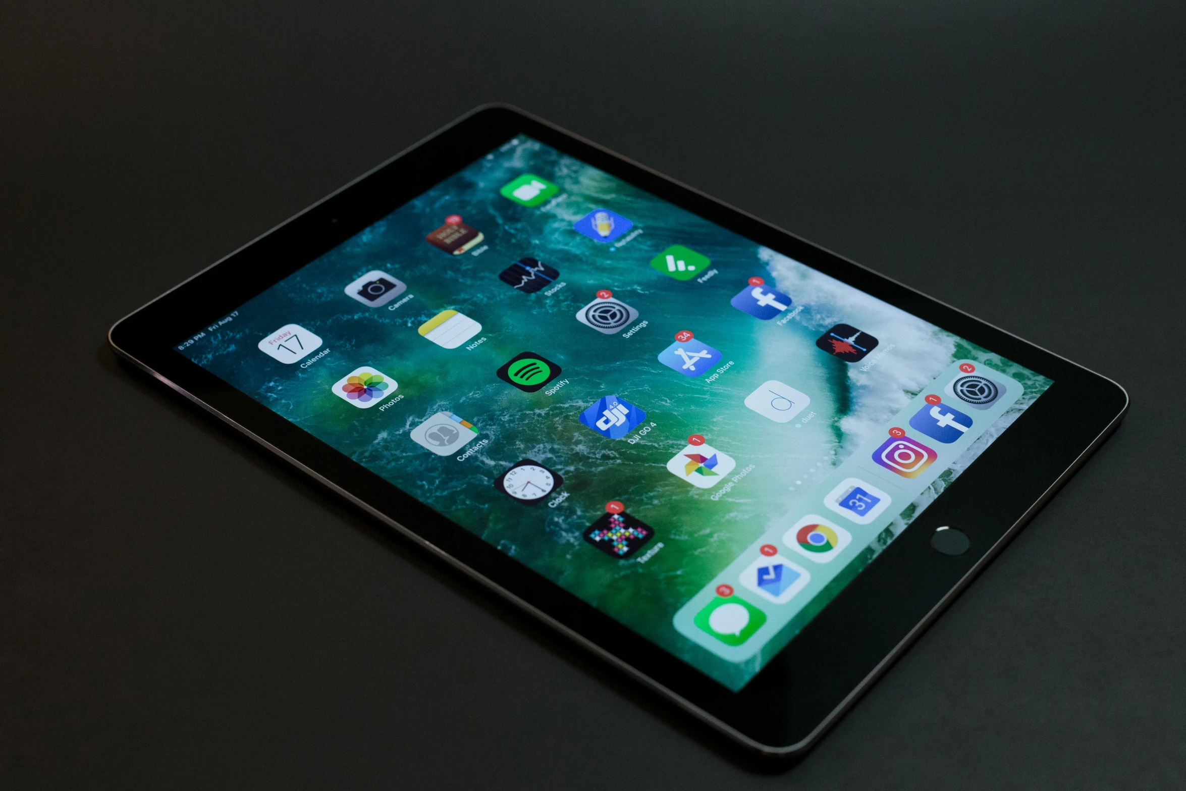 a tablet computer sitting on top of a table, by Carey Morris, pexels, square, panel of black, apple, hyperdetailed