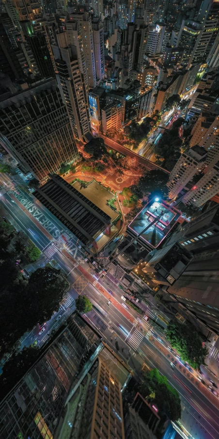 an aerial view of a city at night, by Patrick Ching, unsplash contest winner, photorealistic streetscape, in sao paulo, bird\'s eye view, instagram post