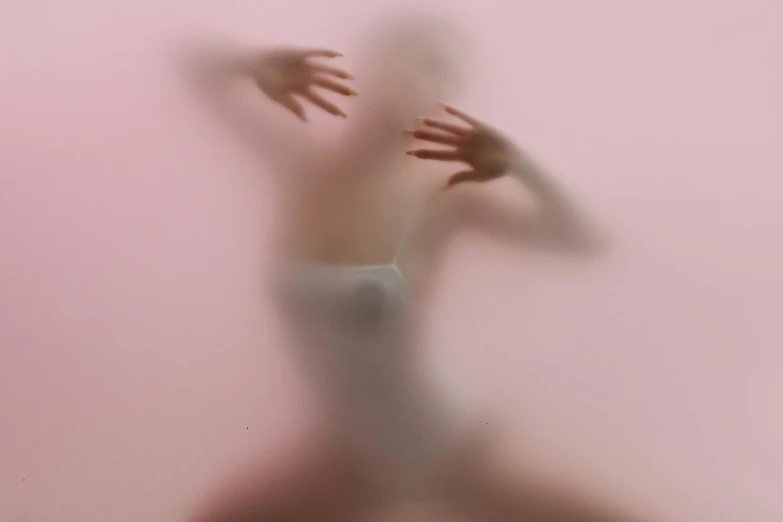 a blurry image of a person doing a handstand, an album cover, inspired by Anna Füssli, figurative art, light pink mist, hands behind her body pose!, floating in perfume, silicone skin