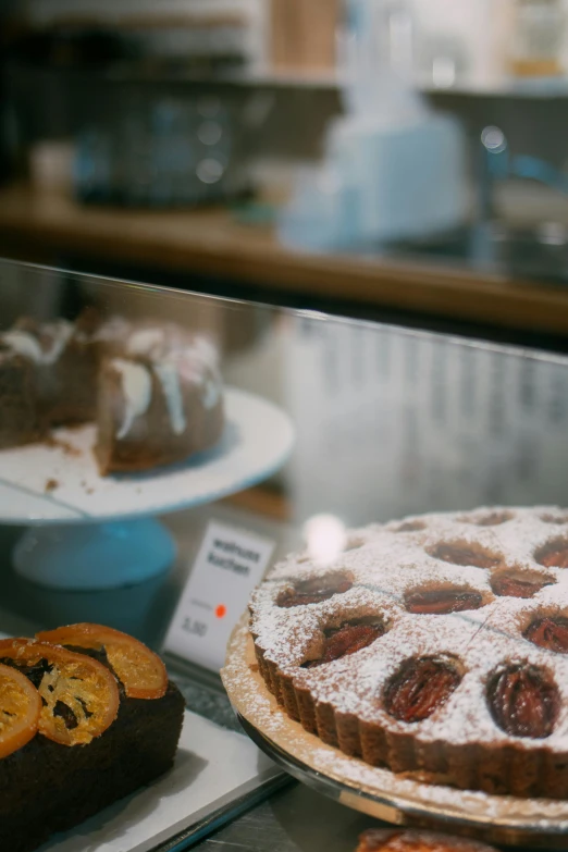 a display case filled with cakes and pastries, inspired by Gillis Rombouts, trending on unsplash, medium shot angle, seasonal, half image, thumbnail