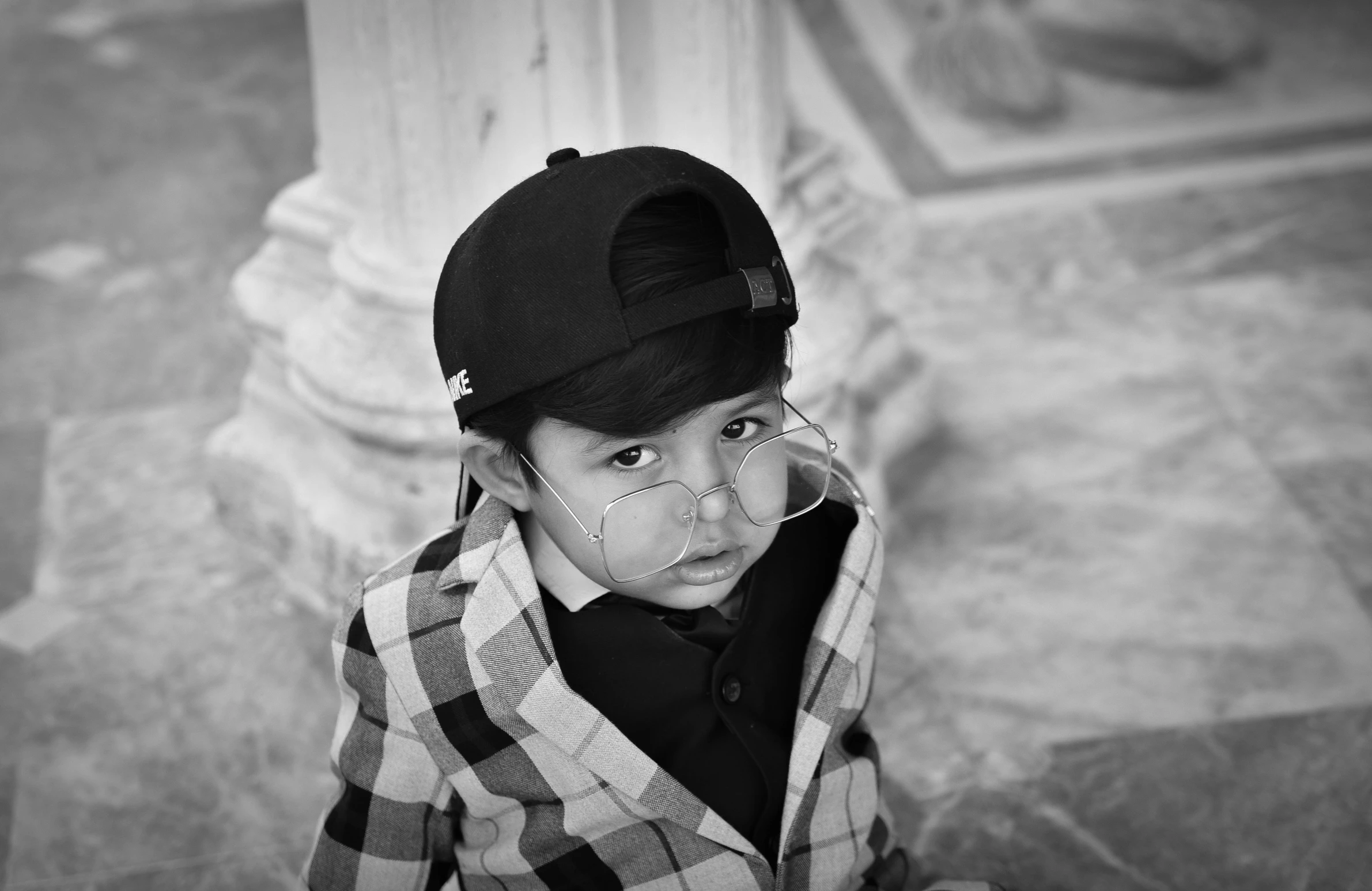 a black and white photo of a young boy, a black and white photo, by Patrick Pietropoli, pexels, surrealism, wearing a cute hat, marble!! (eos 5ds r, mohamed chahin style, elegantly dressed