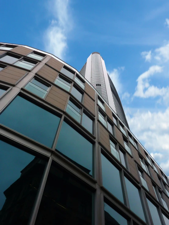 a very tall building with a lot of windows, inspired by Zaha Hadid, unsplash, worm\'s eye view, the shard, slide show, brown