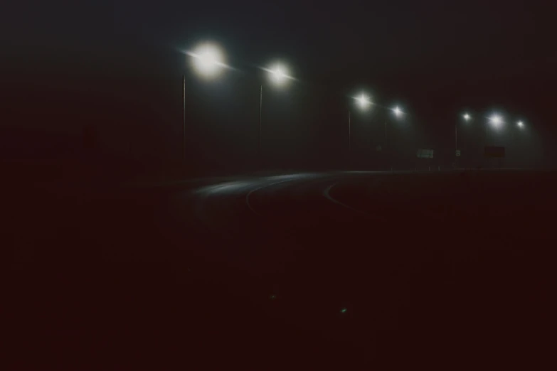 a car driving down a road at night, inspired by Elsa Bleda, postminimalism, lampposts, gray fog, album, dark aesthetic