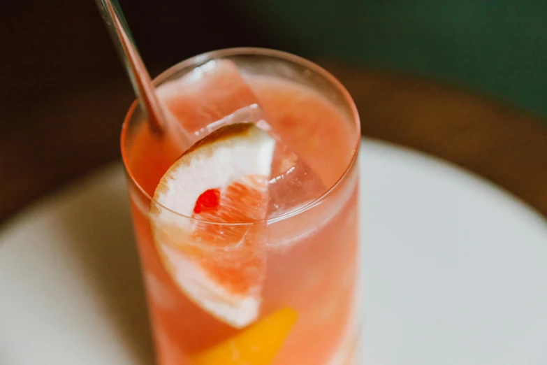 a drink sitting on top of a white plate, unsplash, pink and orange, speakeasy, straw, thumbnail