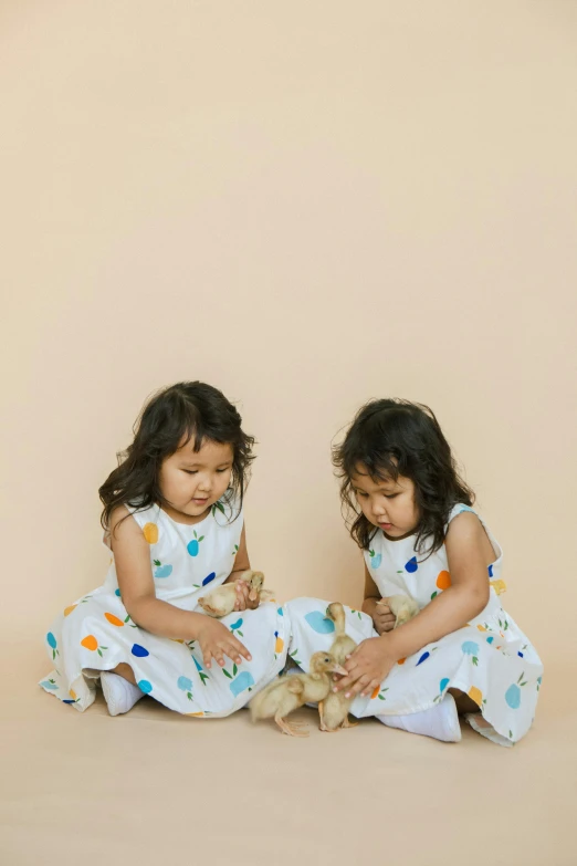 two little girls sitting on the floor playing with a teddy bear, unsplash, process art, organic dress, print ready, gumdrop bunnies, design only