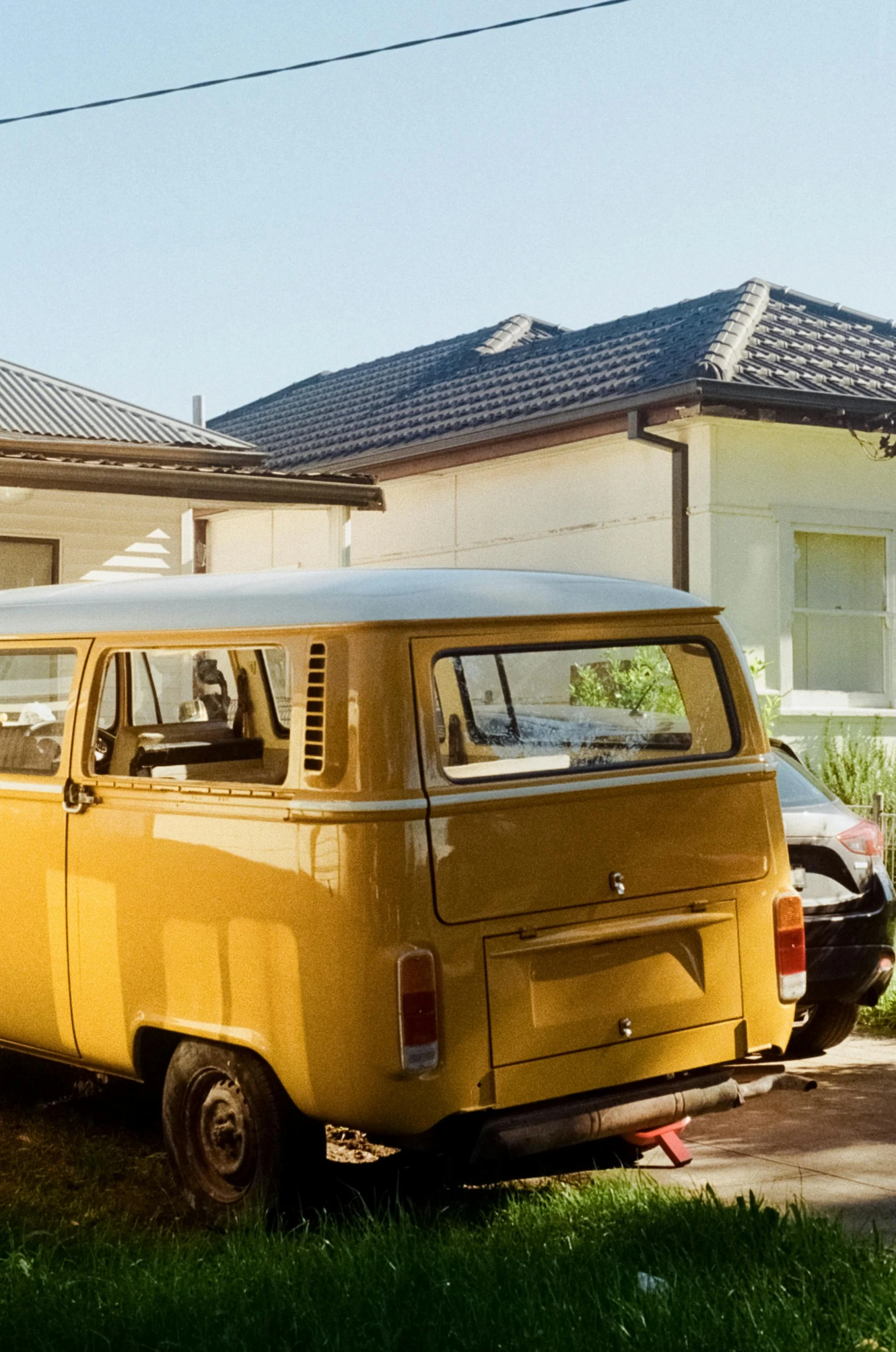 a yellow van parked in front of a house, unsplash, bulli, full morning sun, vintage cars, avatar image