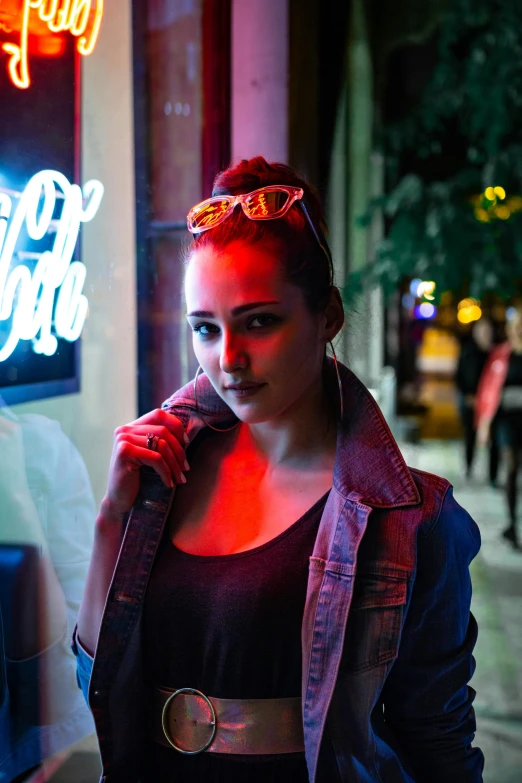 a woman standing in front of a neon sign, a portrait, trending on pexels, handsome girl, light skin, at a bar, cinematic outfit photo