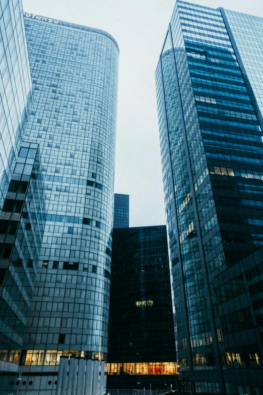 a couple of tall buildings sitting next to each other, by Adam Marczyński, corporate, multiple stories, high quality upload, film photo