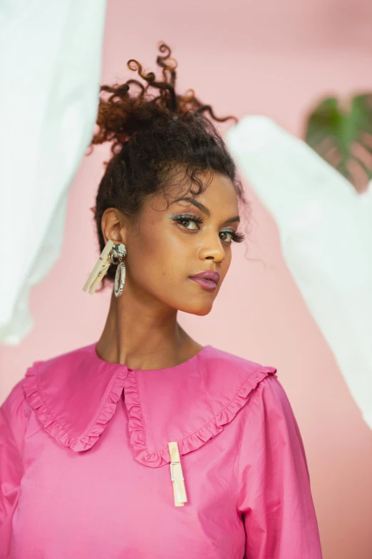 a woman in a pink dress posing for a picture, big earrings, aida muluneh, official store photo, frilled blooming collar