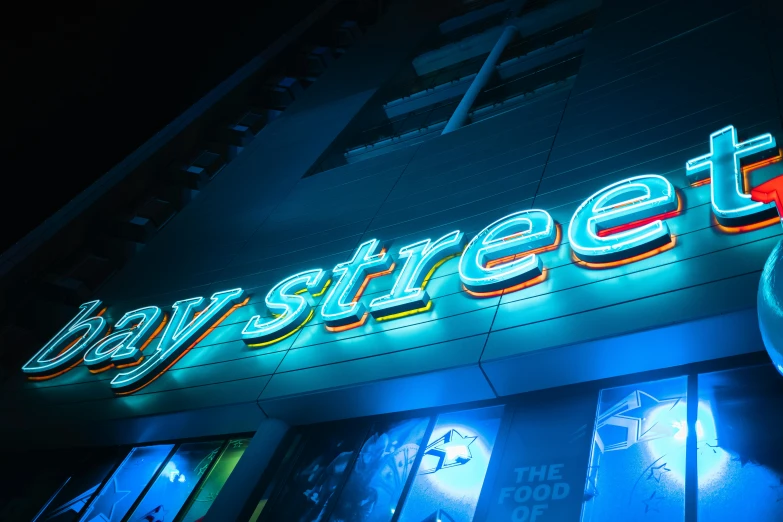 a neon sign on the side of a building, an album cover, pexels, street art, blue steel, ray trace 4 k, busy streets, official store photo