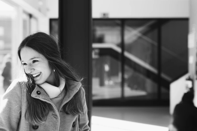 a black and white photo of a woman talking on a cell phone, by Emma Andijewska, smiling girl, in a mall, happy couple, portrait”