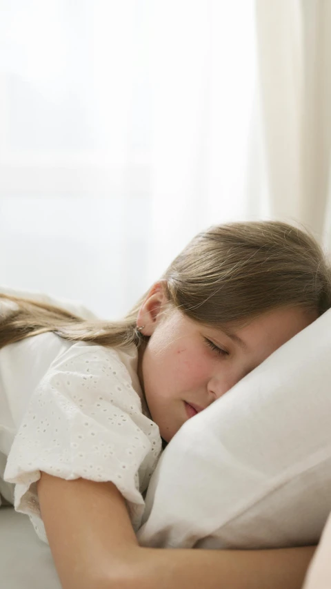 a little girl is sleeping on a bed, pexels, indoor smooth light, thumbnail, half image, aged 13