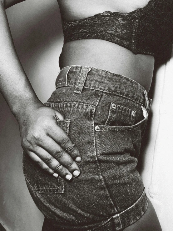 a black and white photo of a woman in a short skirt, by Clifford Ross, trending on unsplash, renaissance, tight denim jeans, 1990s photograph, heavy gesture style closeup, stomach