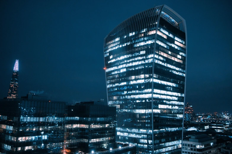 a very tall building sitting in the middle of a city, pexels contest winner, modernism, night time footage, zaha hadid building, endless empty office building, low detailed