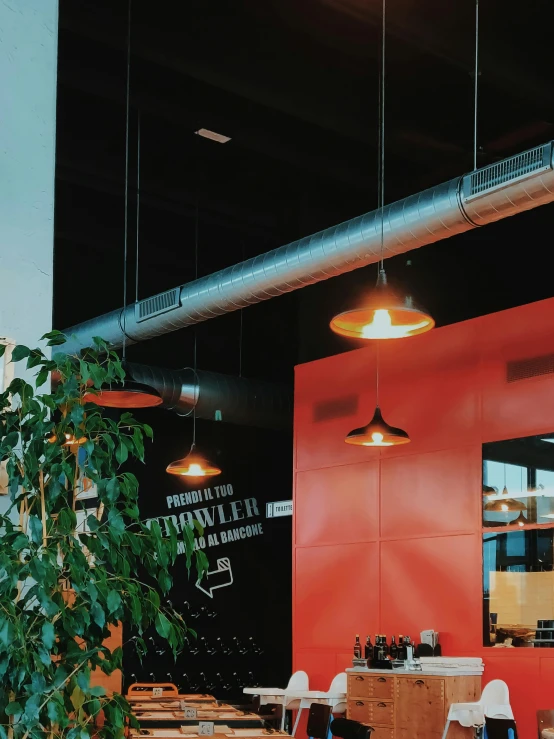 a room filled with lots of tables and chairs, a photo, pexels contest winner, modernism, red light bulbs, building cover with plant, orange and black tones, thumbnail