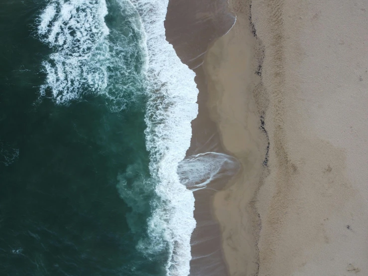 a large body of water next to a sandy beach, pexels contest winner, realism, airborne view, ocean spray, california coast, 4k image”