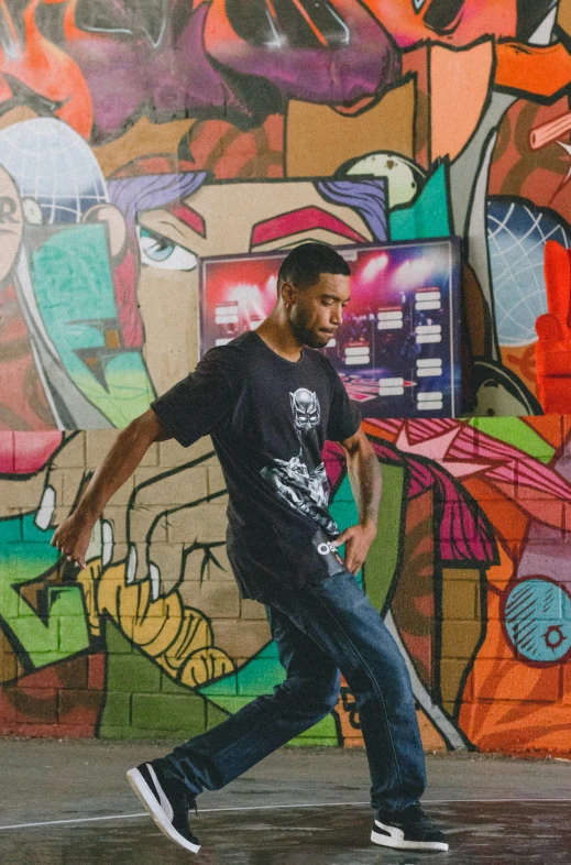 a man on a skateboard in front of a graffiti wall, a portrait, inspired by Francis Souza, unsplash, wearing a tee shirt and combats, classic dancer striking a pose, programming, profile picture