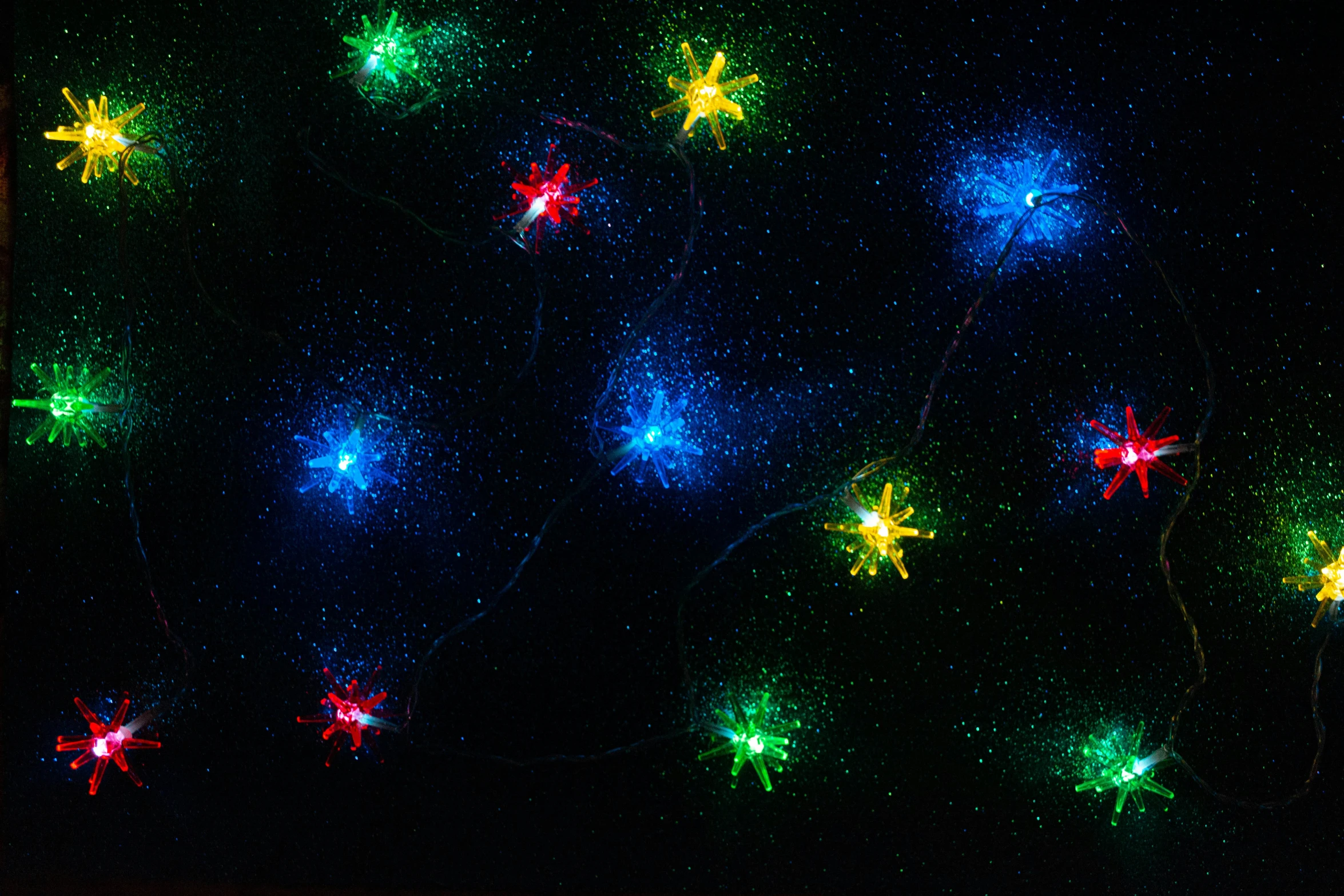 a close up of a string of lights on a wall, vibrant inkbursts, 3 colours, star born, christmas