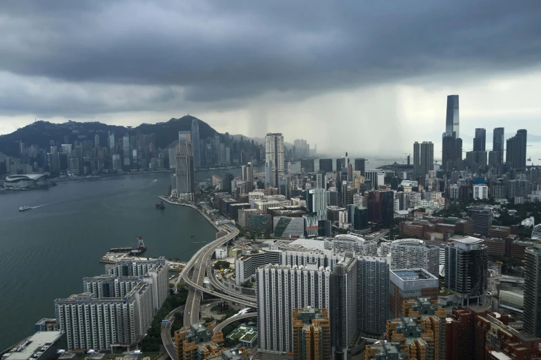 a view of a city from the top of a building, pexels contest winner, hyperrealism, a still of kowloon, bad weather, grey