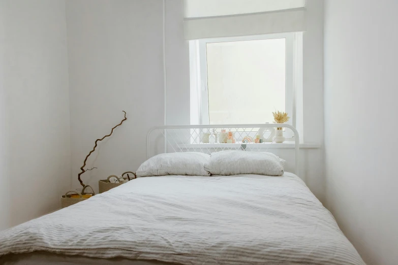 a bed sitting in a bedroom next to a window, inspired by Elsa Bleda, pexels contest winner, light and space, cream white background, white finish, bedroom in studio ghibli, on a pale background