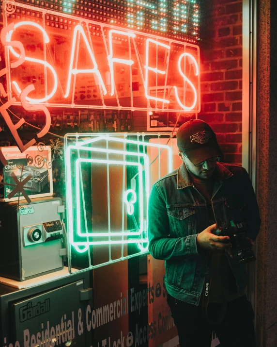 a man standing in front of a store with a neon sign, pexels contest winner, safe, taking a picture, album art, looking in front