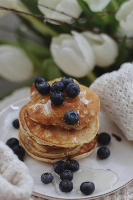 a white plate topped with pancakes and blueberries, bath, botanicals, item, lace