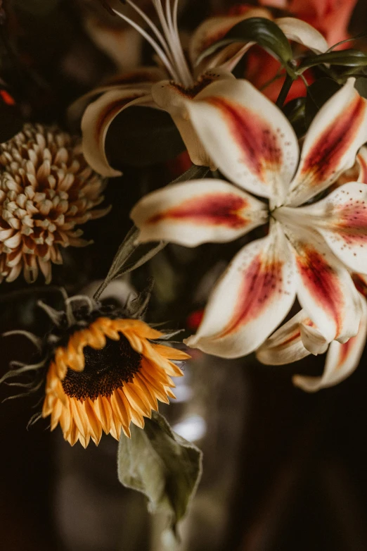 a vase filled with flowers sitting on top of a table, a still life, unsplash, lilies, helianthus flowers, close up details, super detailed image