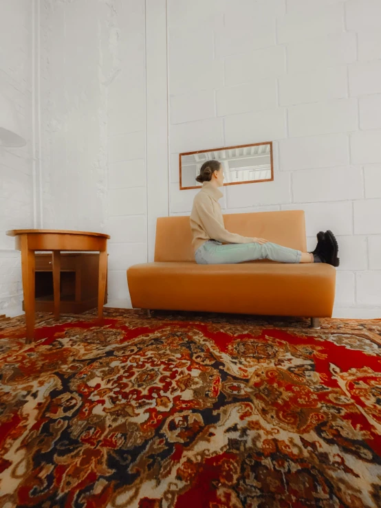 a woman sitting on a couch in a living room, inspired by Sarah Lucas, trending on unsplash, old moist carpet, soviet style, low quality photo, tourist photo