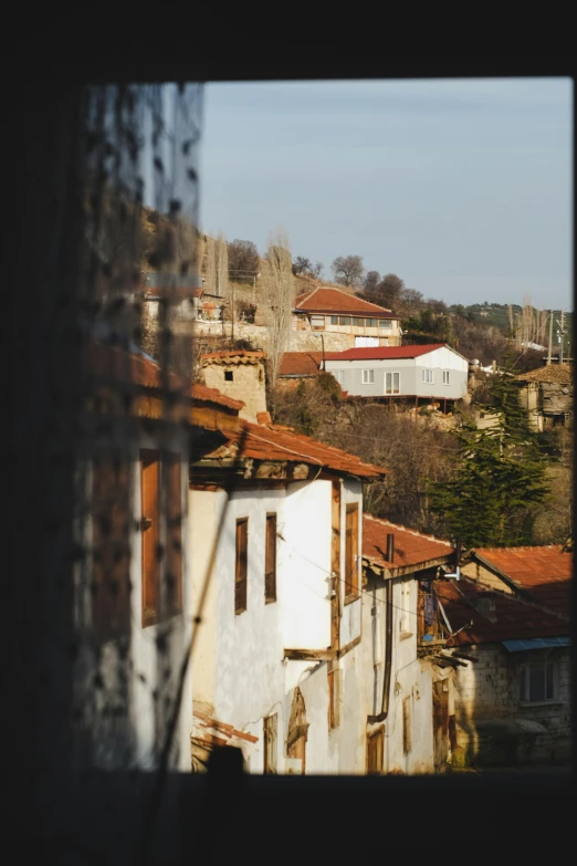 a view of a town through a window, by Tamas Galambos, turkey, square, slightly sunny weather, captured on canon eos r 6