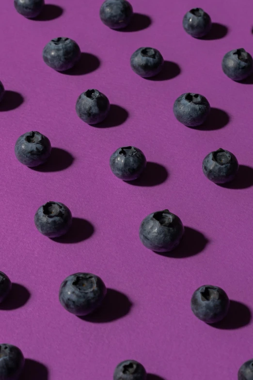 a bunch of blueberries sitting on top of a purple surface, in a row, essence, f / 2 0, made of dots