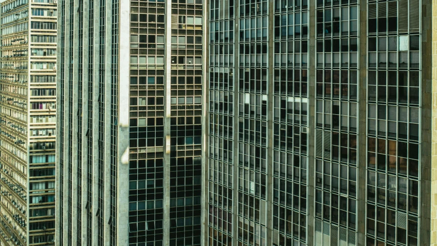 a group of tall buildings next to each other, a detailed matte painting, inspired by Andreas Gursky, pexels contest winner, brutalism, steel window mullions, hong kong buildings, square lines, reflections. shady