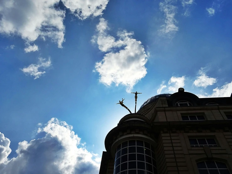 a tall building with a clock on top of it, a photo, inspired by Rene Magritte, unsplash, sunlight through cumulus, épaule devant pose, on a great neoclassical square, blue sky above