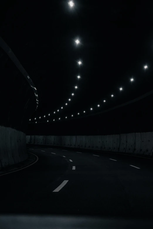 a car driving through a tunnel at night, unsplash, digital art, dark. no text, volumetric lighting - n 9, wall darkness, taken on iphone 14 pro