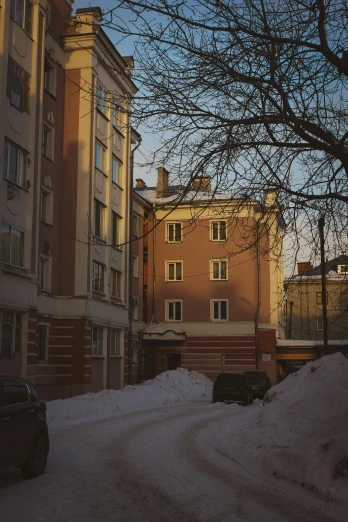 a street filled with lots of snow next to tall buildings, unsplash, socialist realism, medium format. soft light, soviet apartment building, (3 are winter, low iso