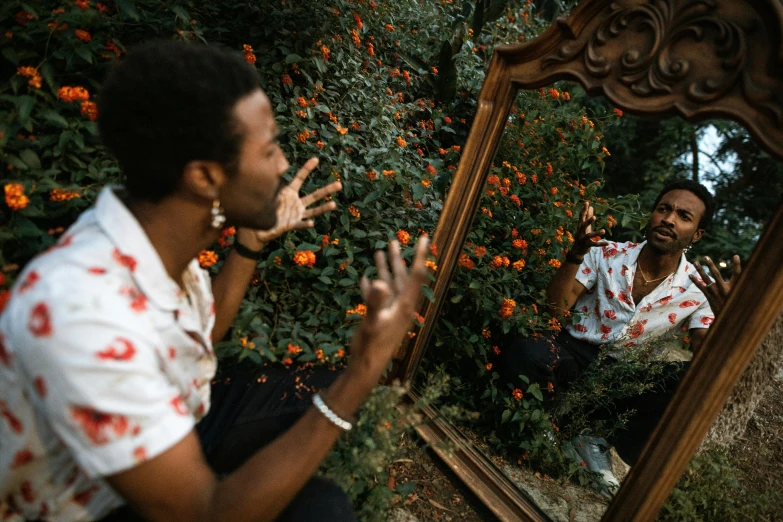 a man that is sitting in front of a mirror, pexels contest winner, in the garden, childish gambino, elaborate composition, blooming