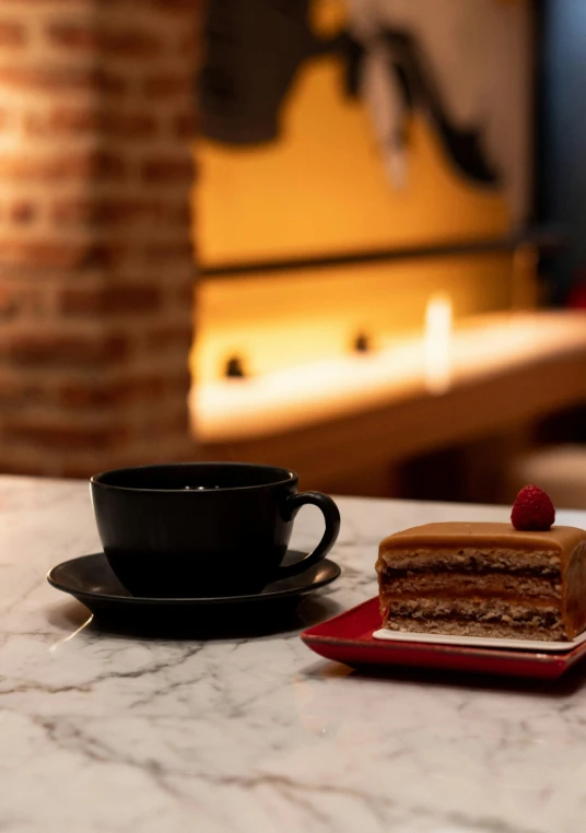 a piece of cake on a plate next to a cup of coffee, inspired by Richmond Barthé, warm lighting inside, black, kek, square