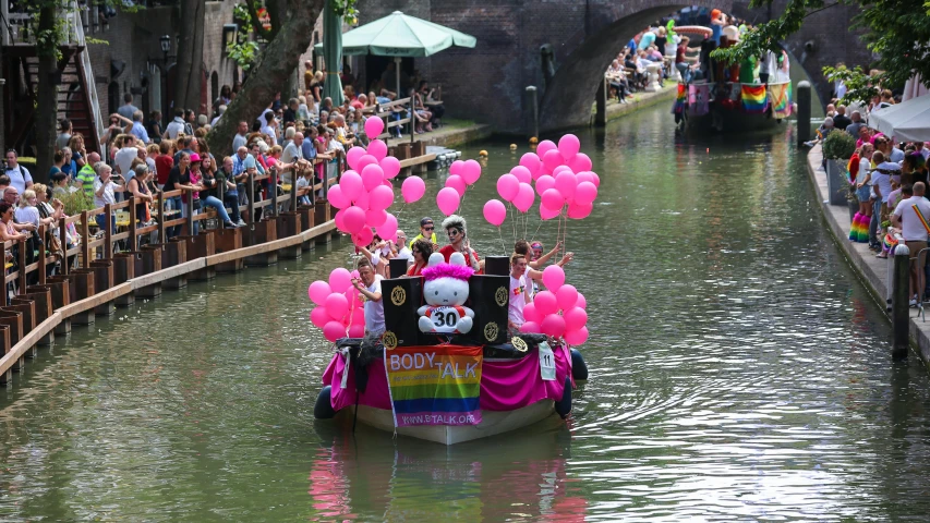 a group of people riding on the back of a boat, by Jan Gregoor, pexels contest winner, covered with pink marzipan, utrecht, felix the cat, float