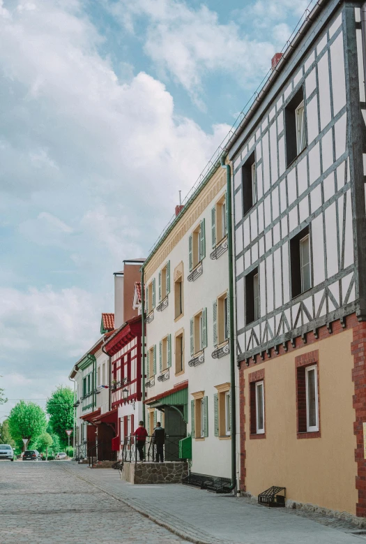 a red fire hydrant sitting on the side of a road, a photo, inspired by Albert Paris Gütersloh, renaissance, wooden houses, 4k shot, large windows to french town, people walking around