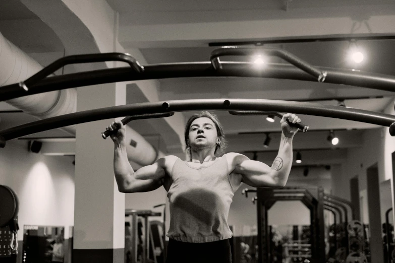 a woman doing pull ups in a gym, by Emma Andijewska, bauhaus, cinematic photo, very accurate photo, 90s photo, fan favorite